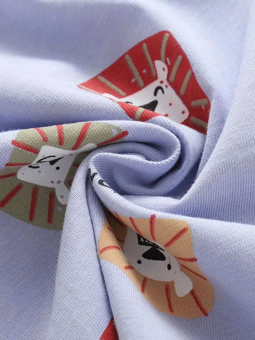 Light blue fabric close-up of lion face print on tee and shorts set