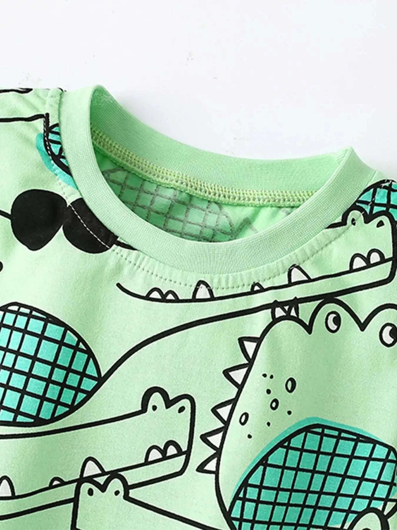 Mint green kids T-shirt with crew neck and black crocodile and scale graphic print