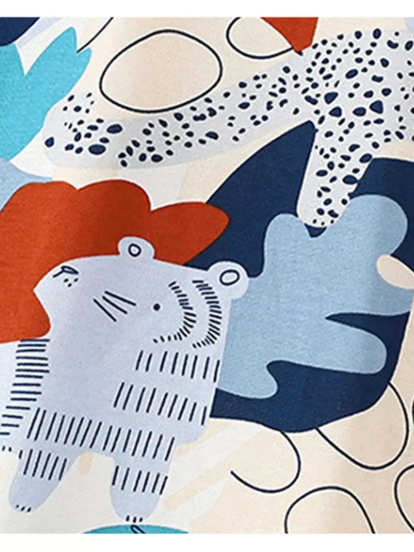 Animal graphic print fabric detail on kids' tee with navy and orange accents