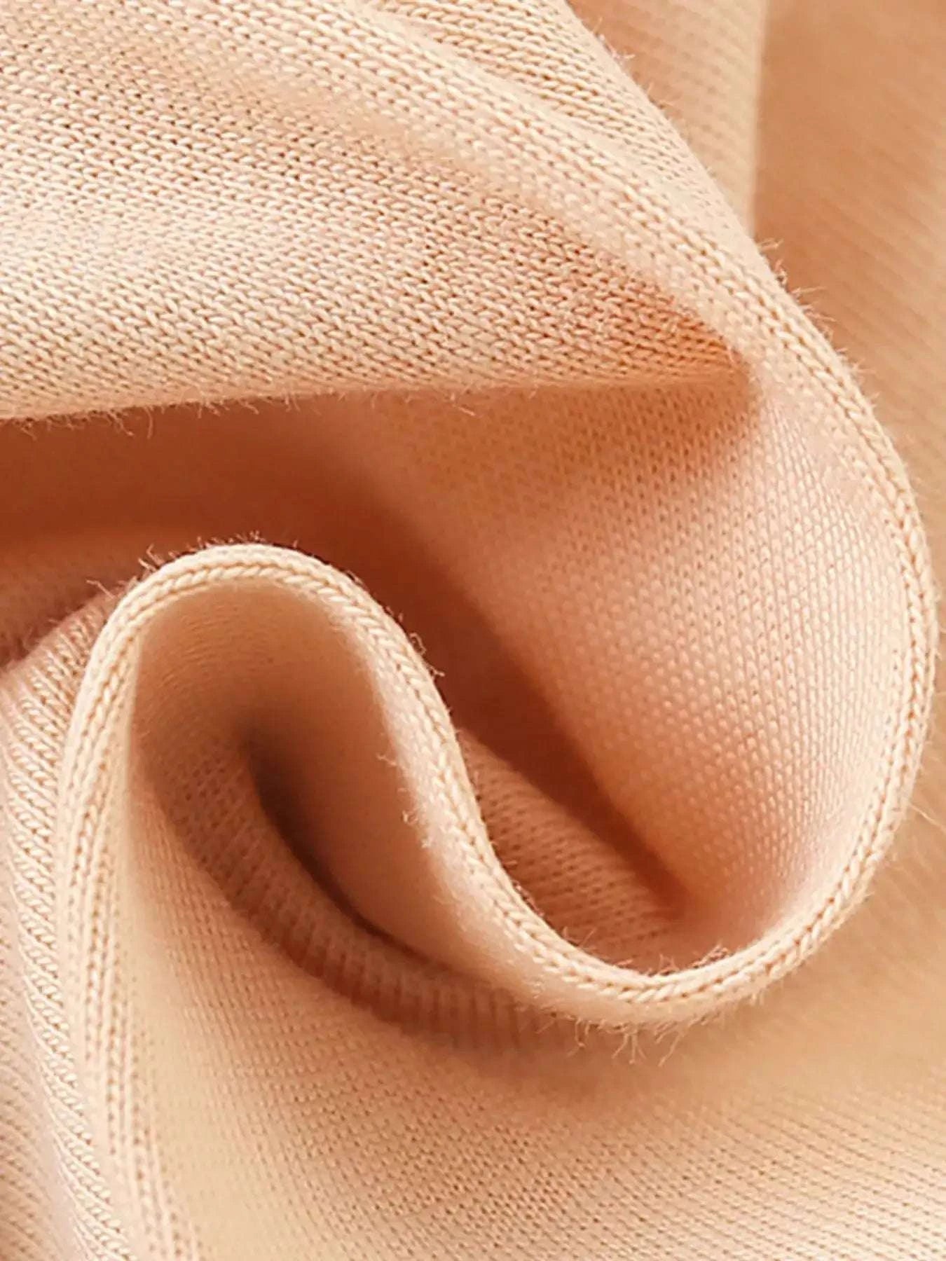 Apricot fabric ruffle sleeve detail with soft stitched edge