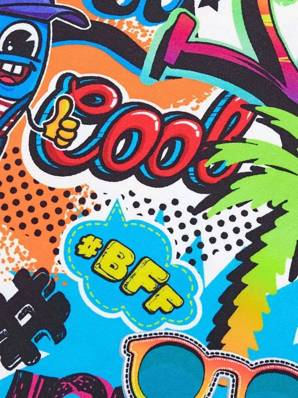 Kids graffiti print T-shirt fabric close-up with cartoon icons and bright colors