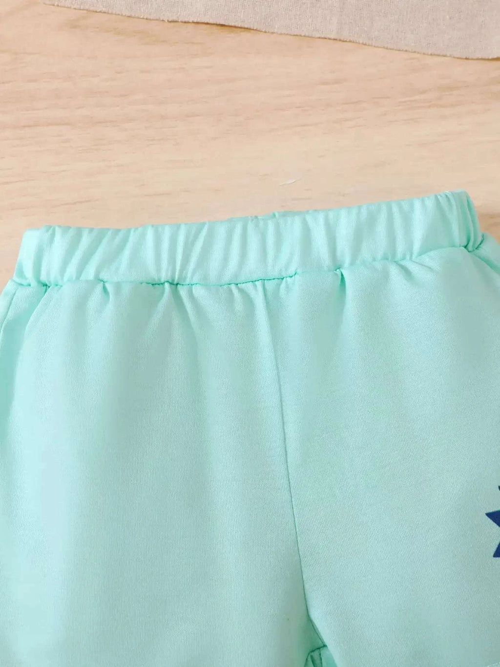 Light blue shorts with elastic waistband and gathered fabric