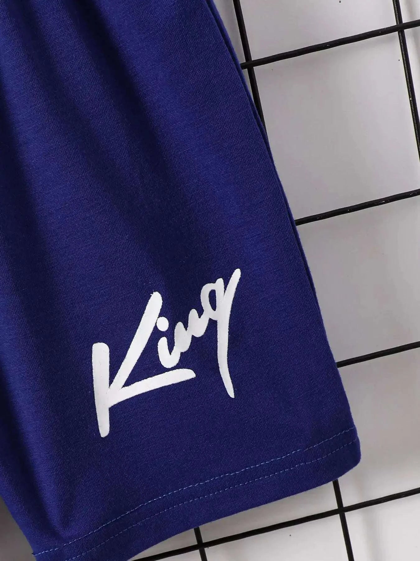 Children's navy-blue shorts hem with white graphic logo on side