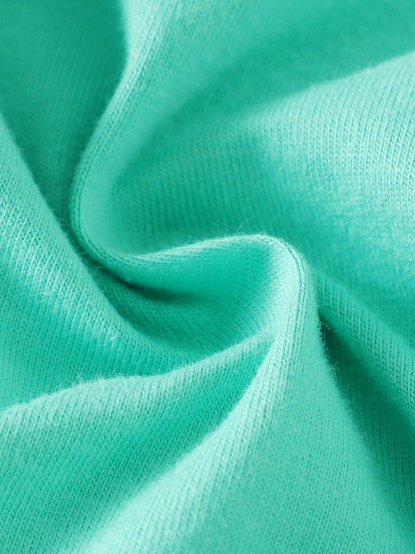 Turquoise knit tee fabric with soft, textured surface