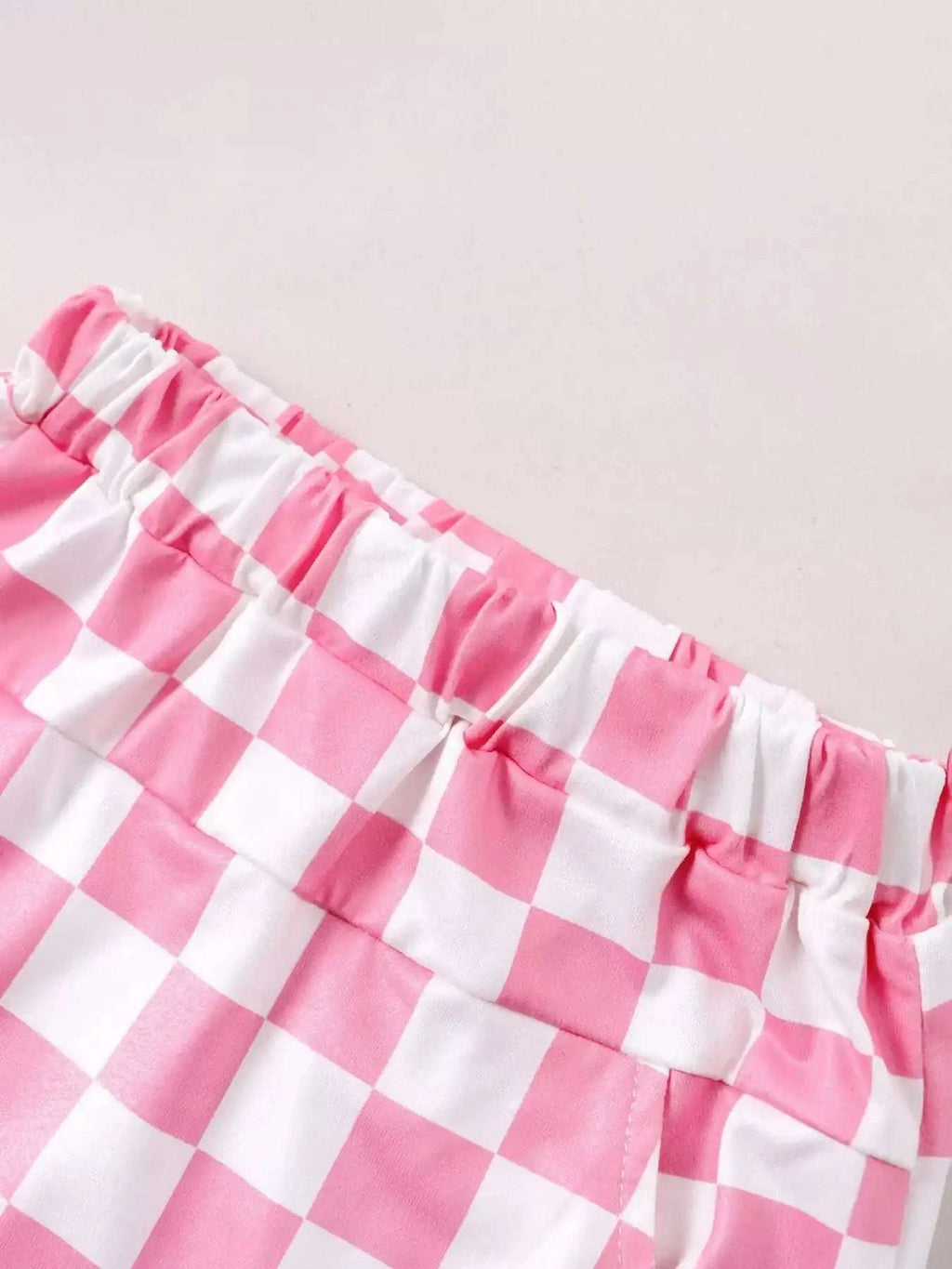 Pink and white checkered kids shorts with gathered elastic waistband