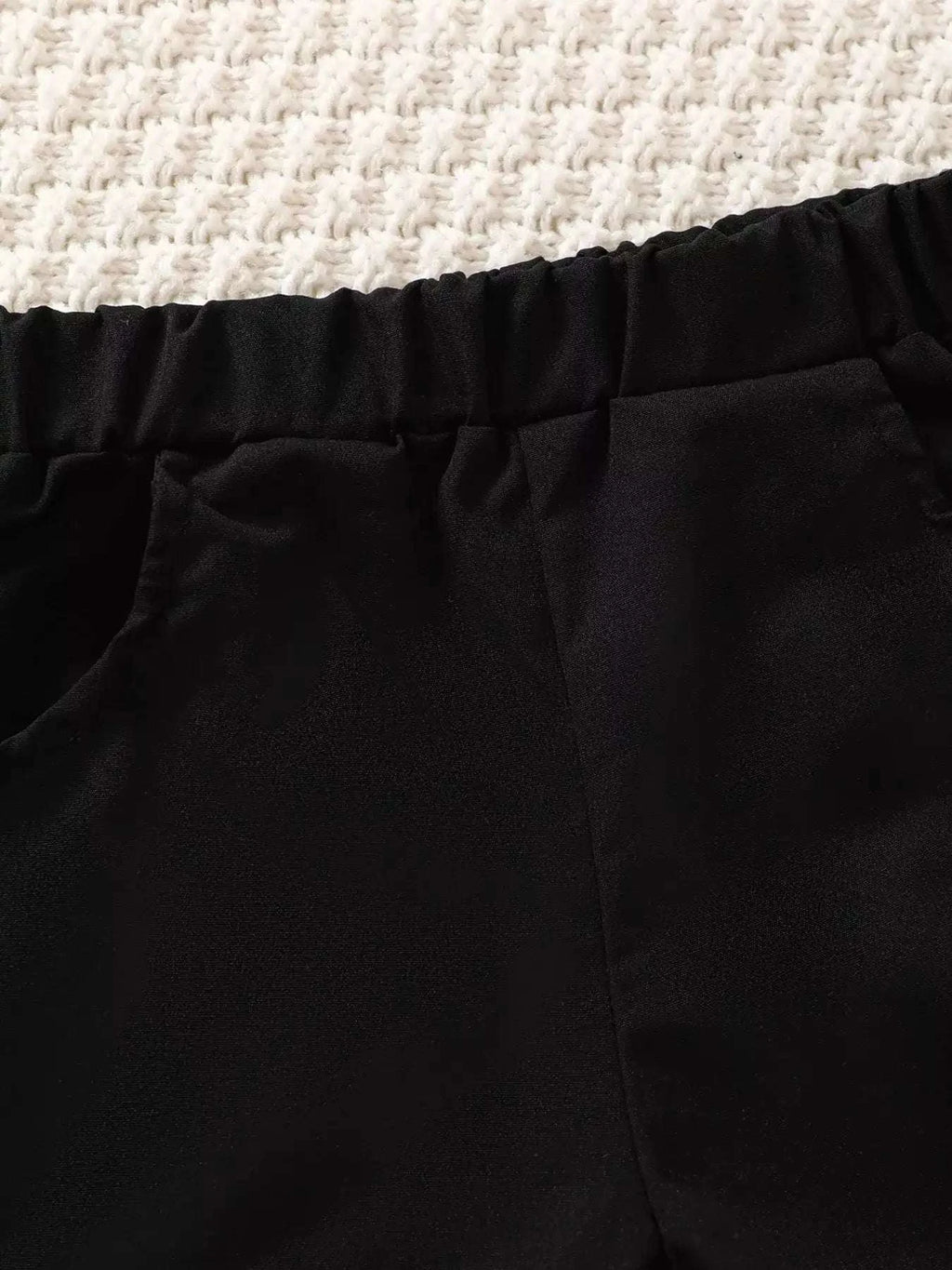 Black shorts with elastic waistband and stitched seam detail.