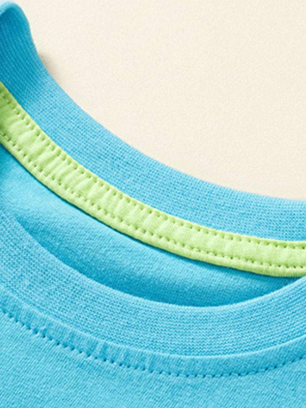 Pastel blue short-sleeve tee neckline with contrast green inner collar seam