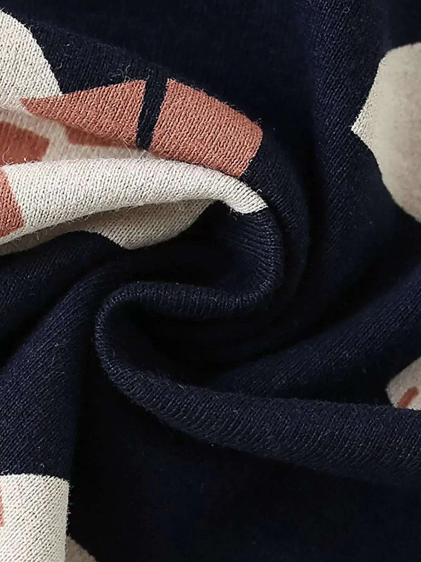 Kids dark navy tee fabric close-up with dinosaur print cuff