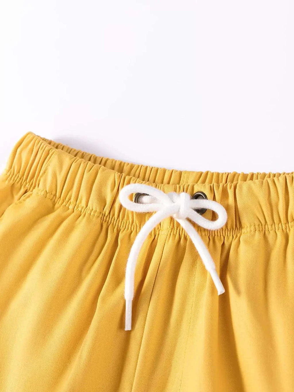 Yellow kids shorts with elastic waistband and white drawstring