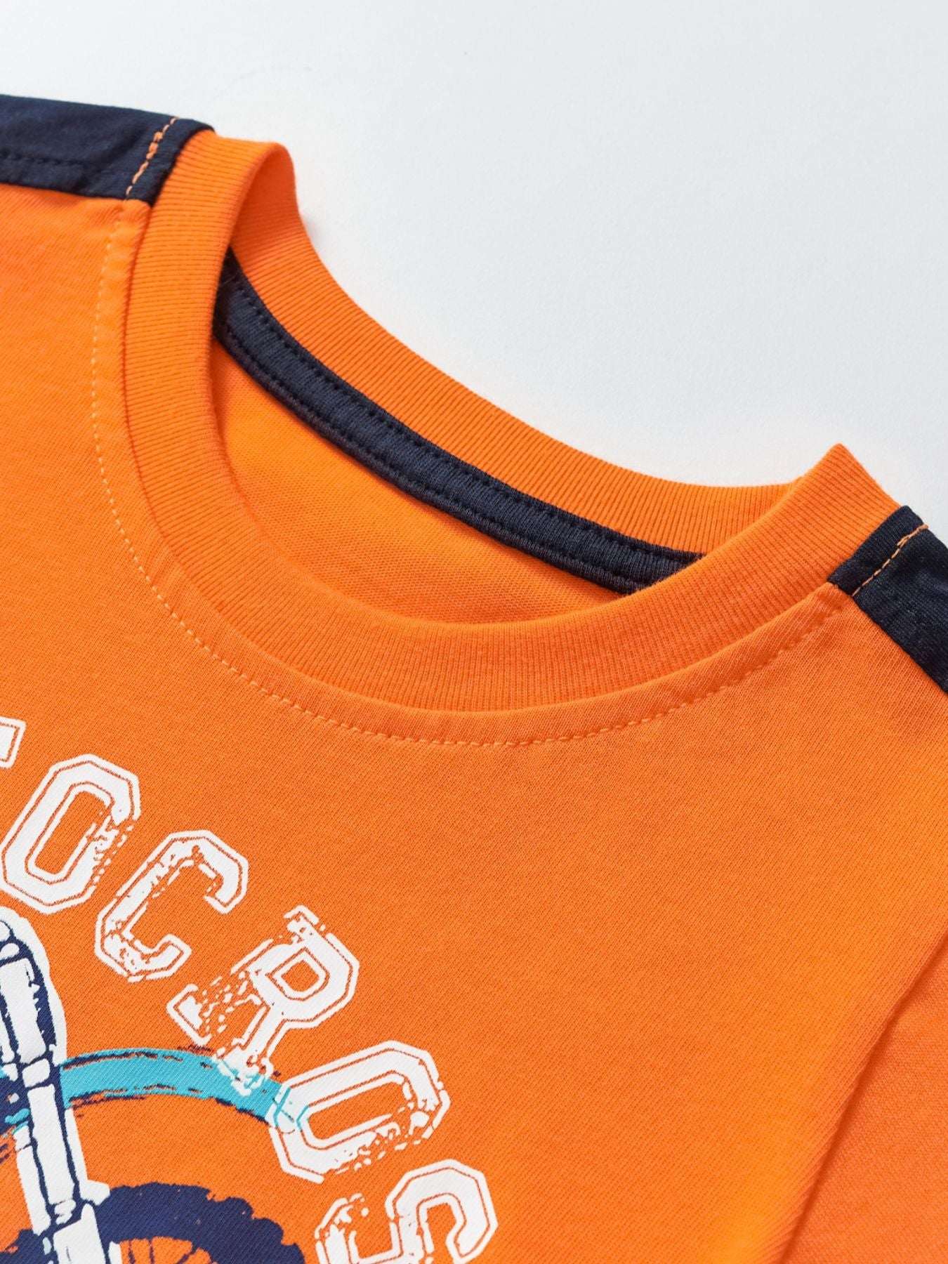 Children's orange short-sleeve tee with navy-trim collar and large graphic print