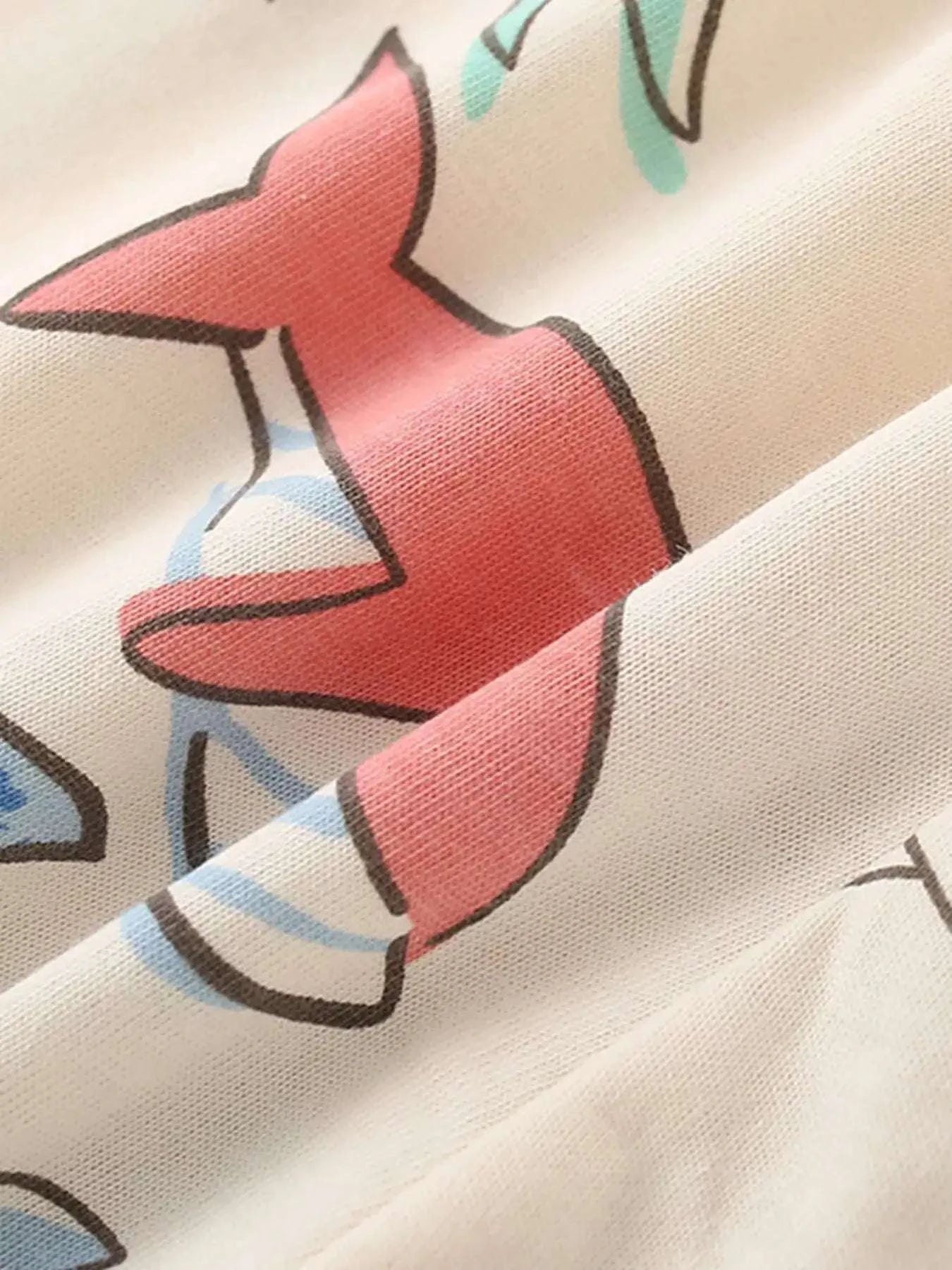 Beige ocean print kids tee fabric close-up with pink starfish graphic