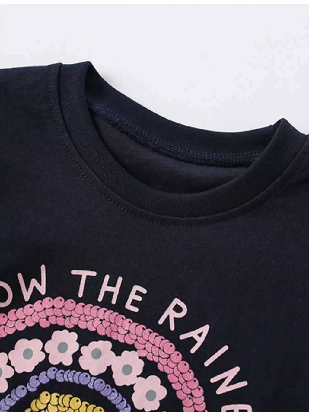 Kids dark T-shirt with partial rainbow sequined graphic near the neckline