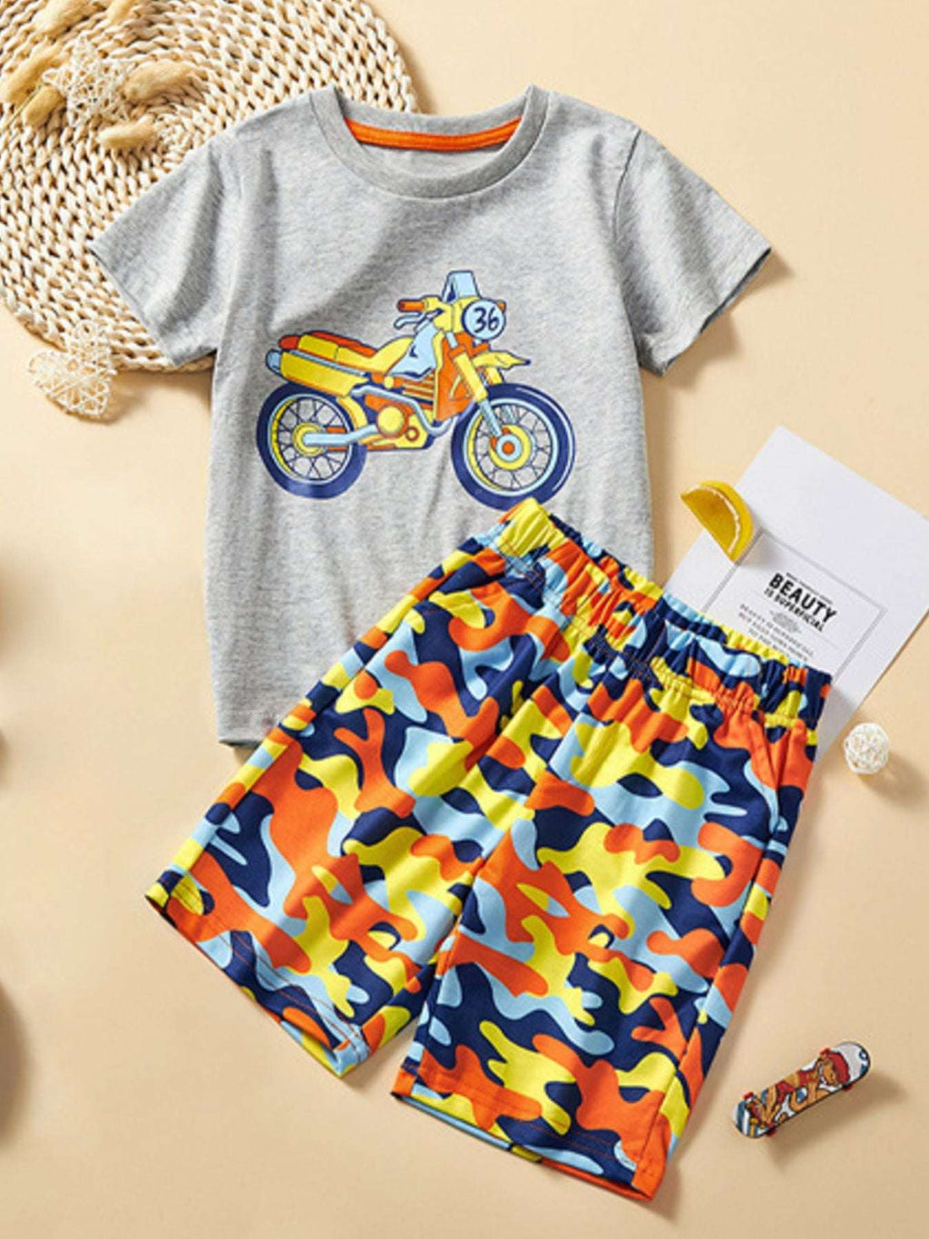 Light gray crew-neck T-shirt with vehicle graphic, matching colorful shorts