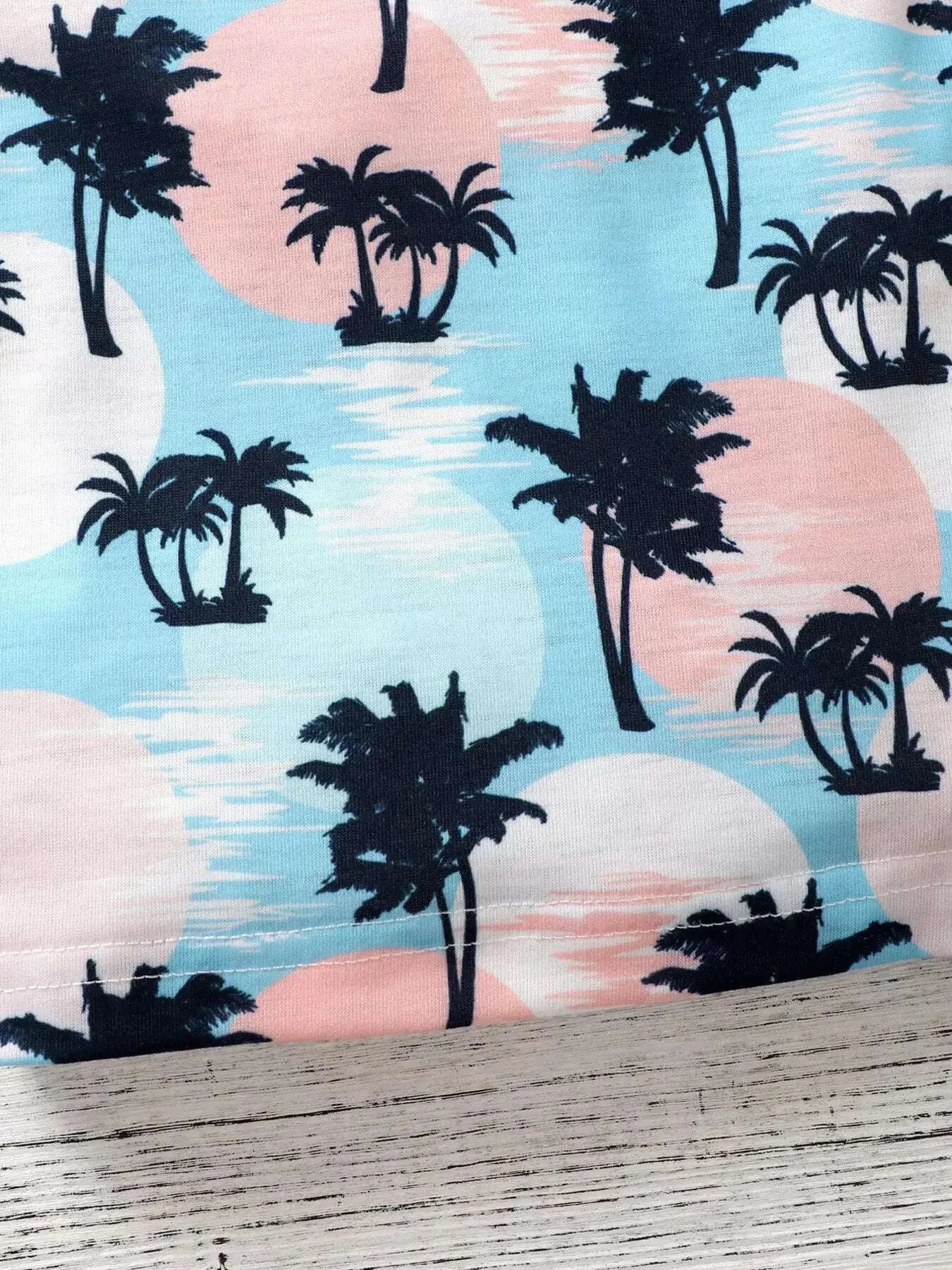 Kids palm print tee fabric with black palms on light blue and pink shapes