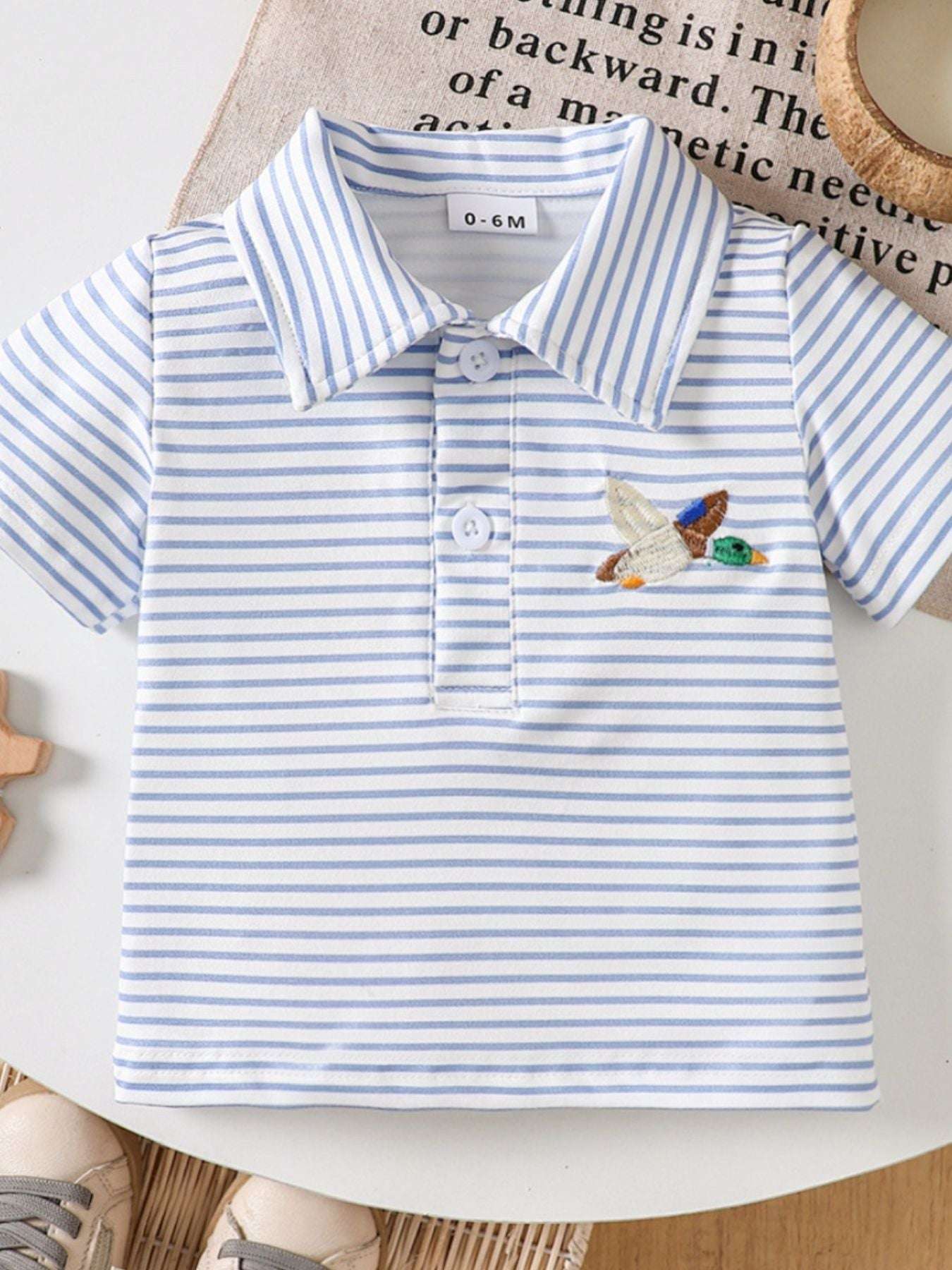 Striped polo shirt in blue and white with duck embroidery on the chest
