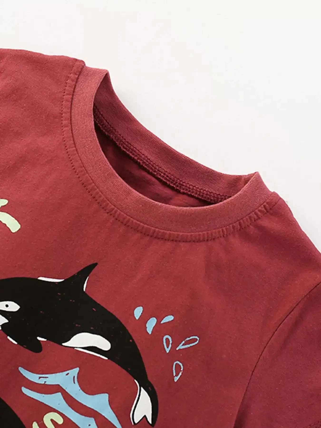 Burgundy children's graphic T-shirt with crew neck and partial orca print