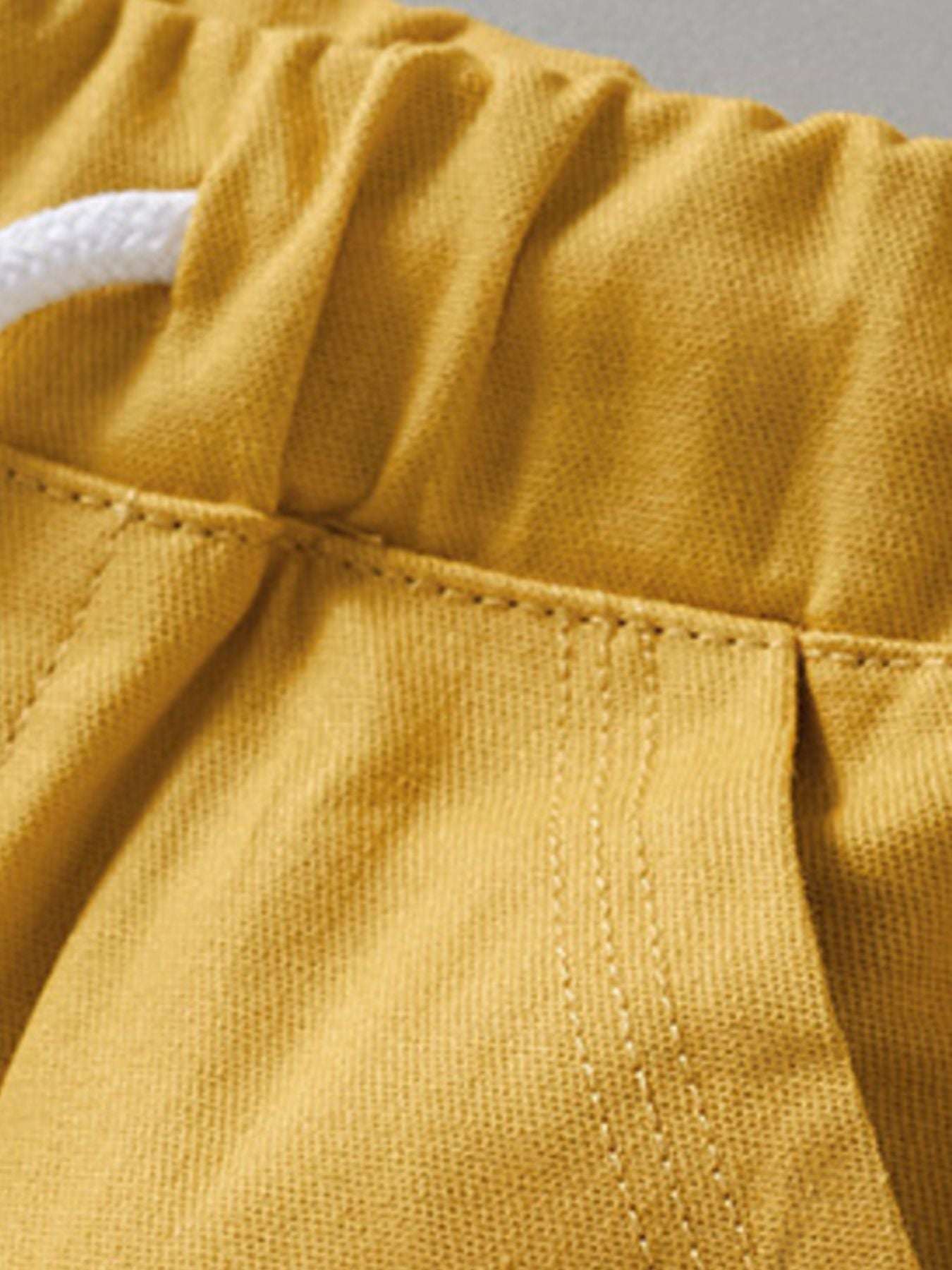 Yellow kids shorts waistband with elastic and stitched drawstring channel