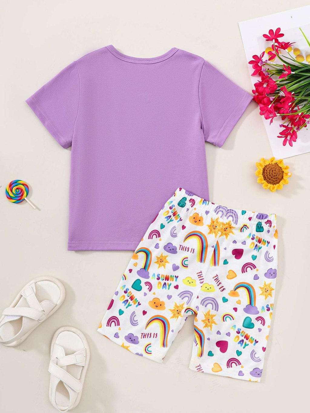 Kids purple short sleeve tee and white sunny day print shorts set, front view