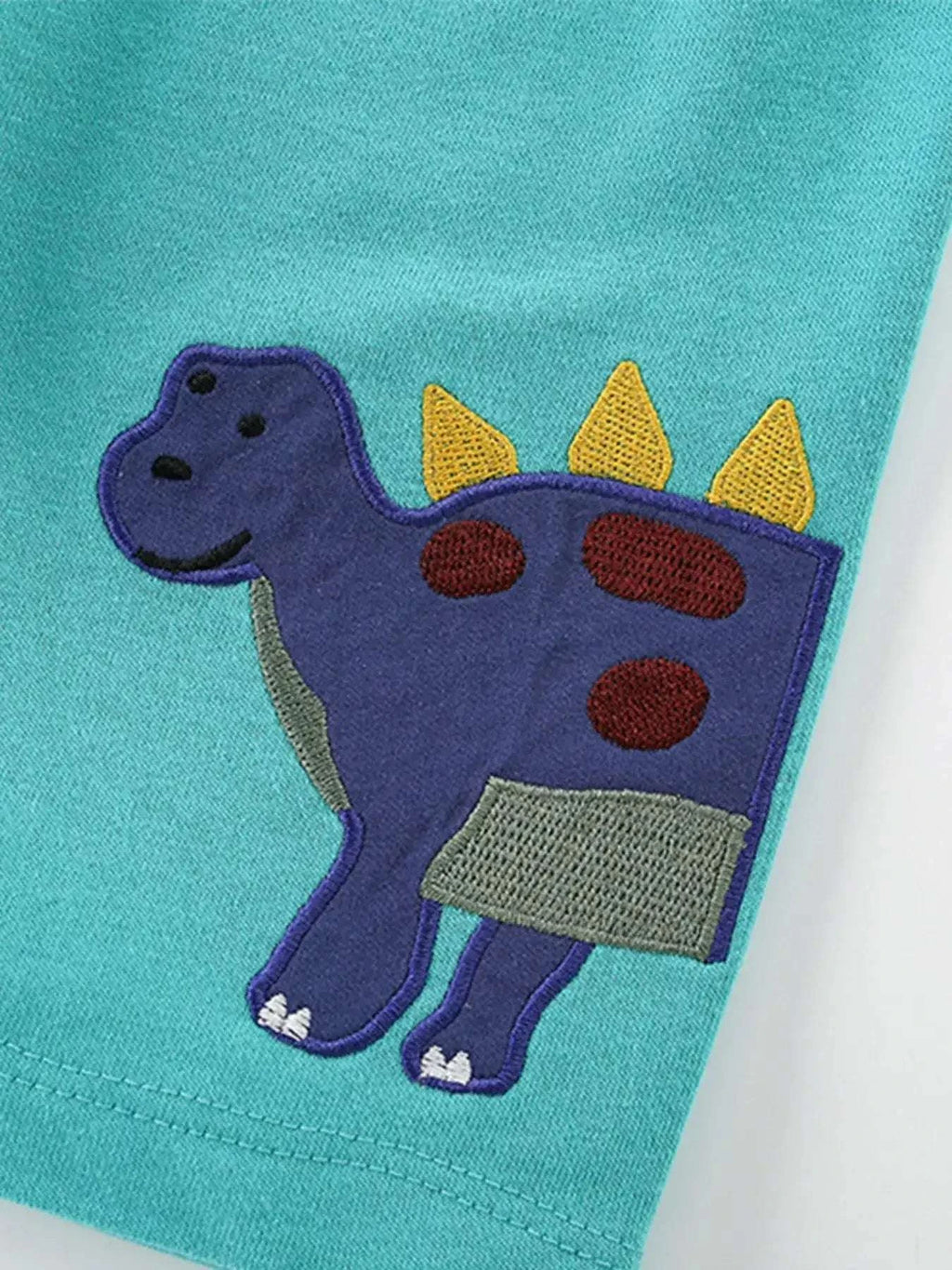 Teal kids t-shirt with purple dinosaur applique and red spots