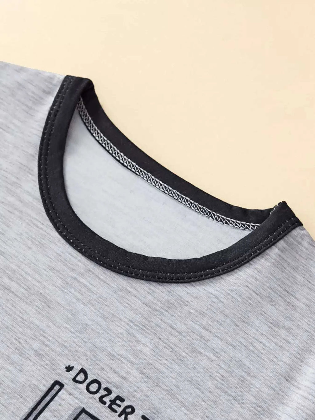 Heather gray kids tee neckline with black crew collar and contrast stitching