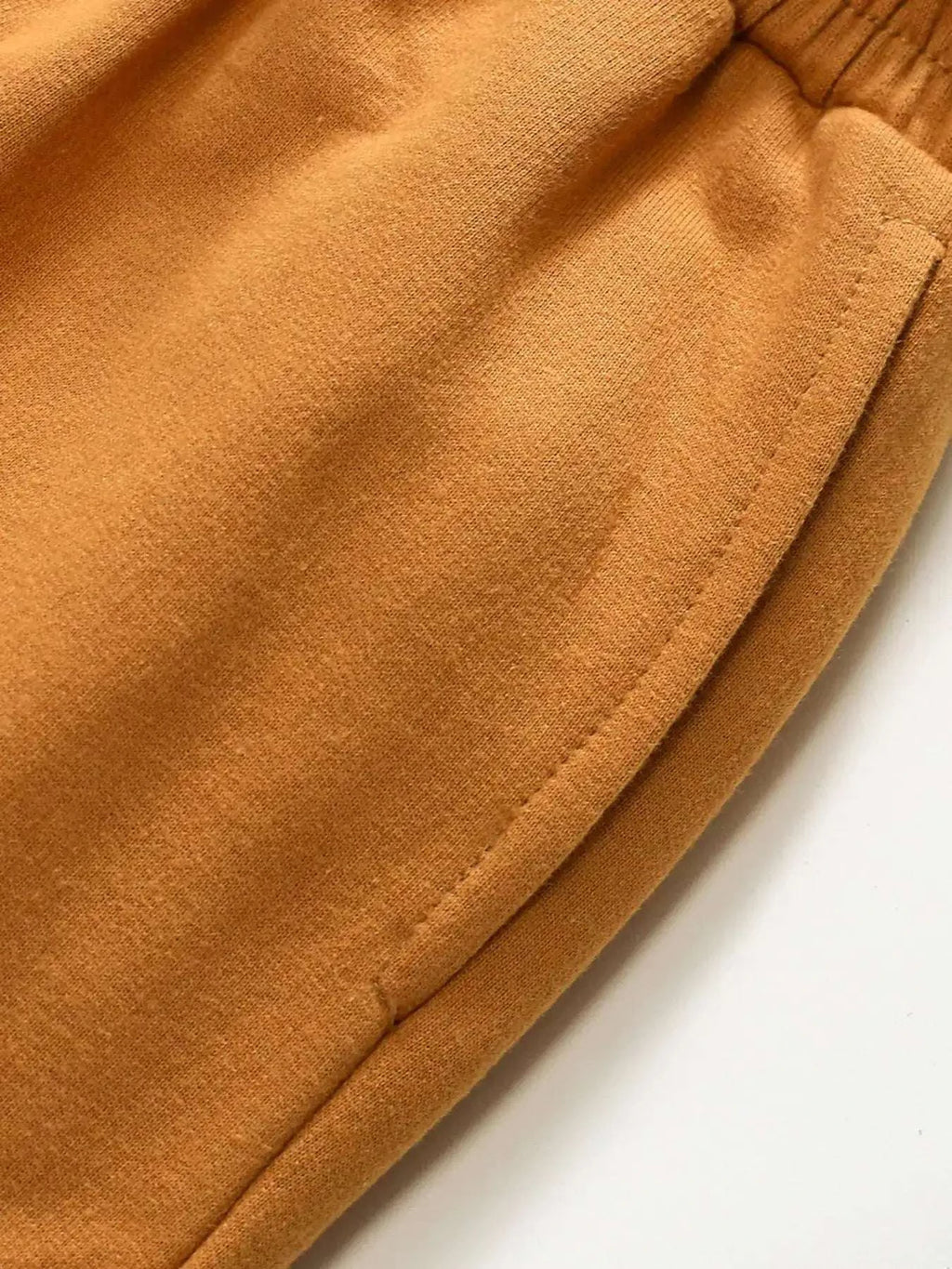 Children's mustard shorts with stitched hem and visible side seam