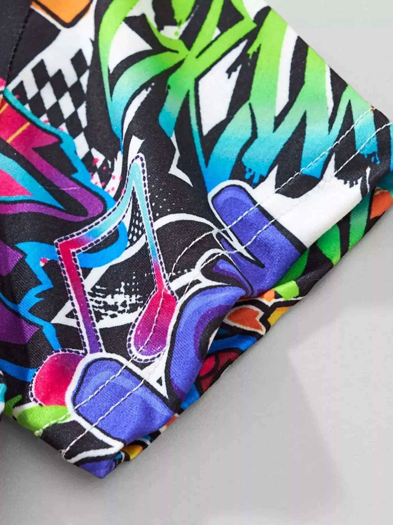 Kids graffiti T-shirt sleeve hem close-up with colorful graphic stitching