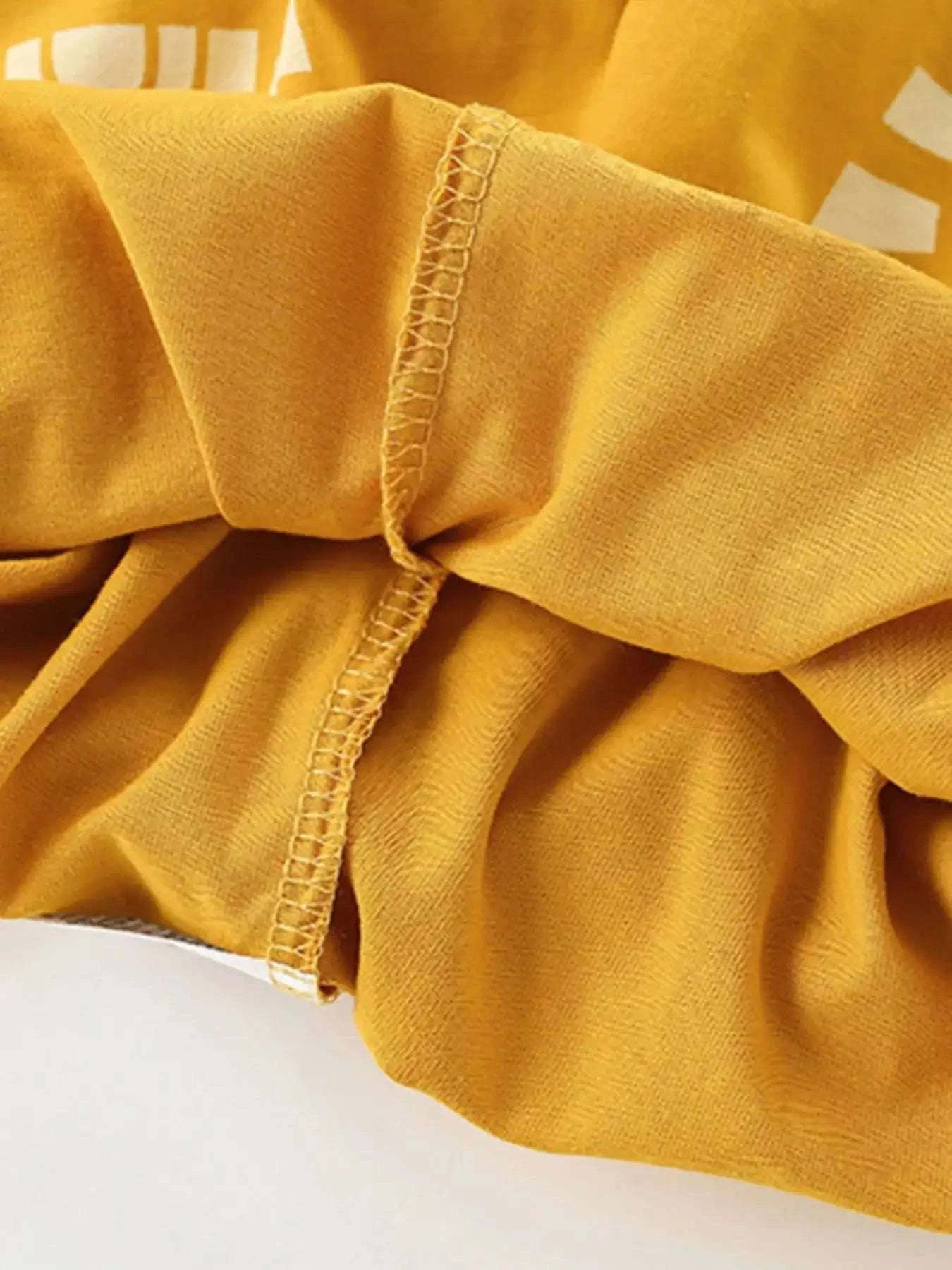 Gold short-sleeve tee with gathered sleeve hem and visible stitching