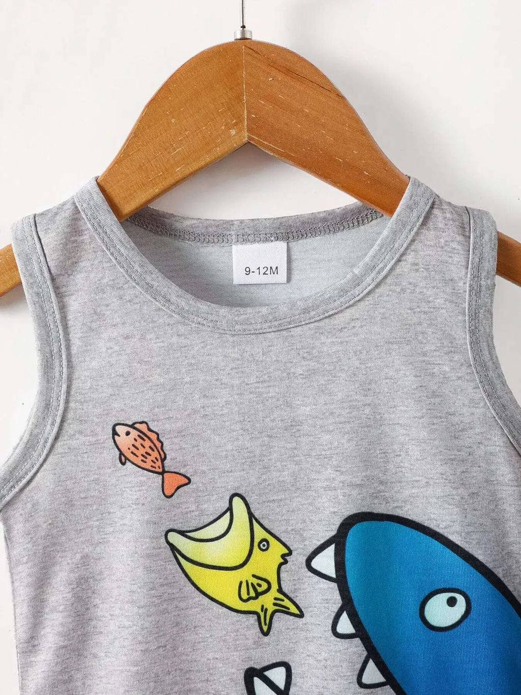 Gray sleeveless tank top with shark and fish graphic, crew neckline.