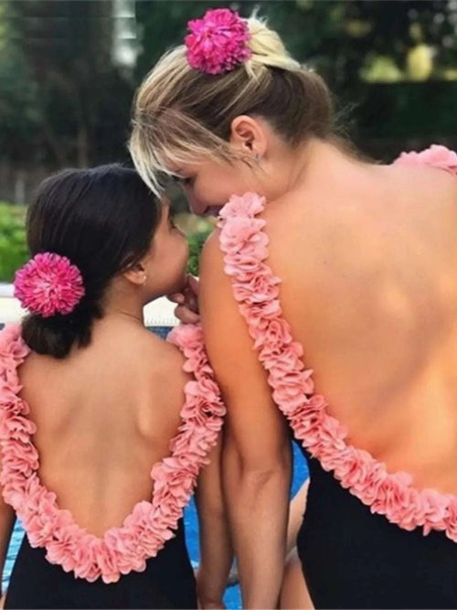 Backless petal strap swimsuit, black one-piece with pink ruffled trim and backless straps