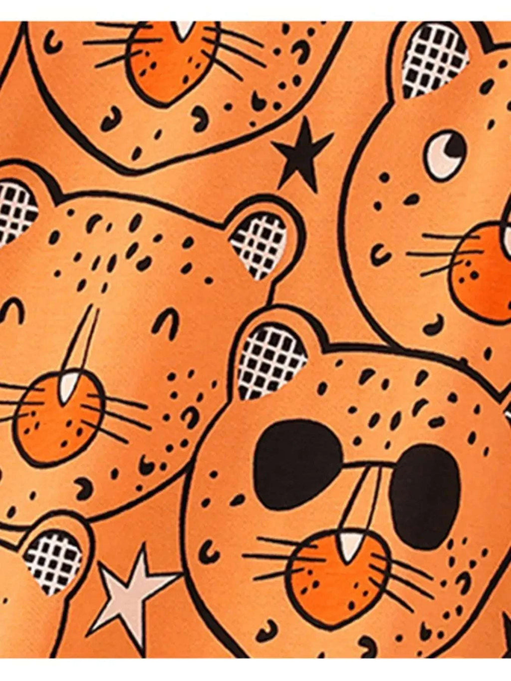 Orange bear-print fabric close-up with outlined cat faces, stars, and checkered ears