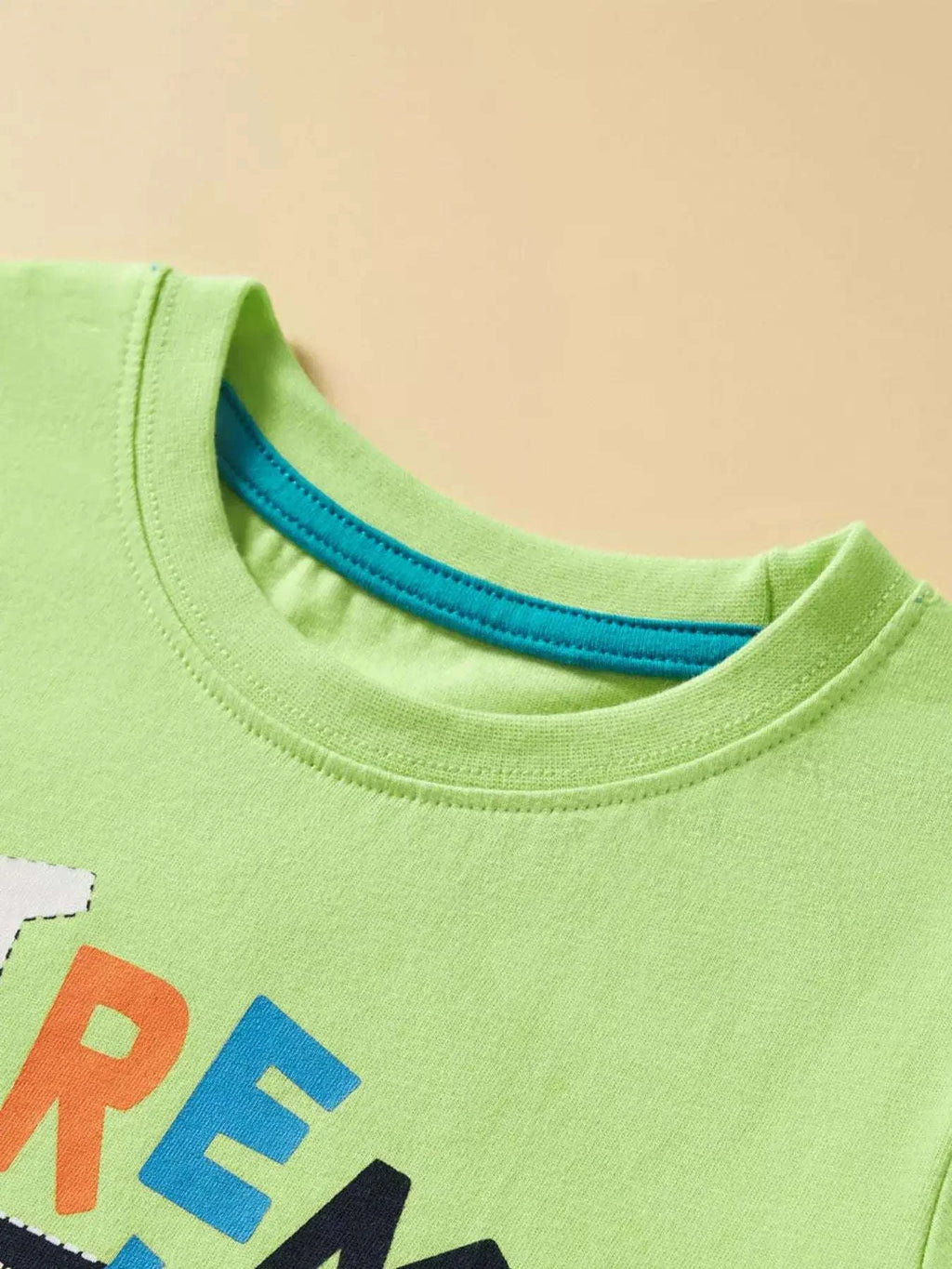 Neon green kids graphic T-shirt, crew neck with blue trim at collar