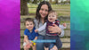 mother and two sons sitting on park bench